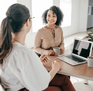 Two people in an interview smiling